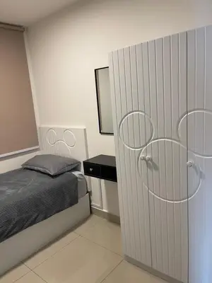 a bedroom with a bed and a door with a mirror at One Majestic Ipoh - 3 Bedroom Apt For Family of 5 in Ipoh