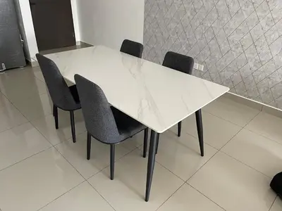 a white dining table with black chairs in a room at One Majestic Ipoh - 3 Bedroom Apt For Family of 5 in Ipoh