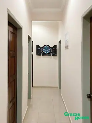 a hallway with a wall with a clock on it at Ipoh Town Bangalow Canning Garden Football Table in Ipoh
