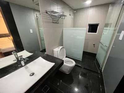 a bathroom with a sink and a toilet and a mirror at MARITIME SUITES DUPLEX MARVELOUS SEA VIEW in George Town
