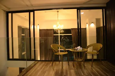 a dining room with a table and chairs and a chandelier at MARITIME SUITES DUPLEX MARVELOUS SEA VIEW in George Town