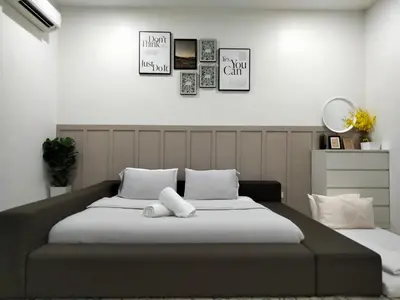 a bedroom with a large bed with white pillows at RS Homestay in Sungai Petani