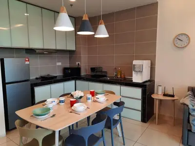 a kitchen with a wooden table and blue chairs at Onsen Suite at Sunway Lost World Tambun in Ipoh