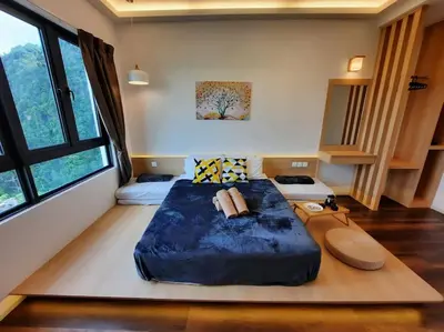 a bedroom with a large blue bed in a room at Onsen Suite at Sunway Lost World Tambun in Ipoh