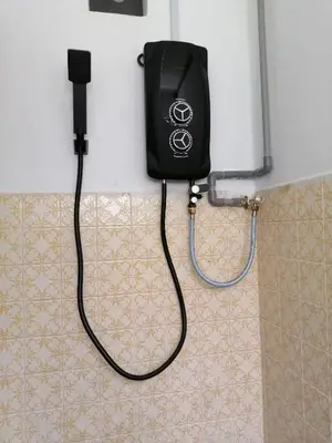 a bathroom with a blow dryer hanging on the wall at Destiny Homestay in Sungai Petani