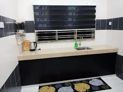 a kitchen with a sink and a window at 61 Homestay in Sitiawan