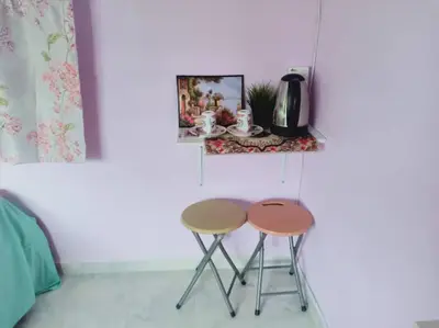 two nesting tables in a room with a wall at Inap Desa 2 in Baling