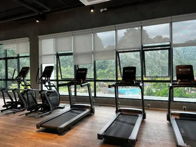 a gym with rows of exercise bikes in front of windows at Ipoh Peaceful Onsen studio Lost World Tambun in Tambun
