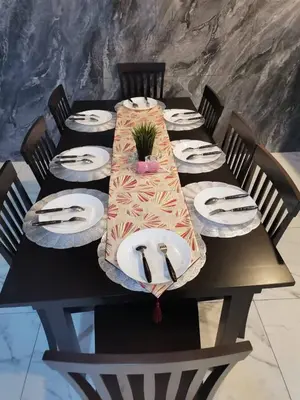 a black table with plates and a plant on it at SBB Star Homestay in Sungai Petani