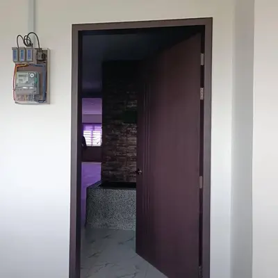 a door leading into a room with a brick wall at SBB Star Homestay in Sungai Petani