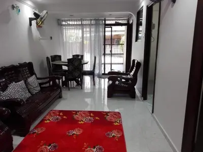 a living room with a couch and a red rug at Idaman guesthouse Malay FAMILY ONLY in Kubang Semang