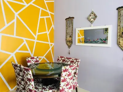 a dining room with a glass table and two chairs at LIYANA AAISYA HOMESTAY - 10 UNITs - JOINT VENTURE PARTNERS in Tanah Rata