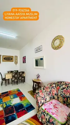 a living room with a couch and a rug at LIYANA AAISYA HOMESTAY - 10 UNITs - JOINT VENTURE PARTNERS in Tanah Rata
