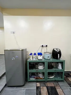 a kitchen with a green cabinet and a refrigerator at Roomah Istana in Ipoh