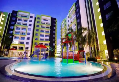 a large pool with a playground in front of some buildings at Ipoh Homestay - Manhattan Condominium with Water Park & Leisure Facilities in Ipoh