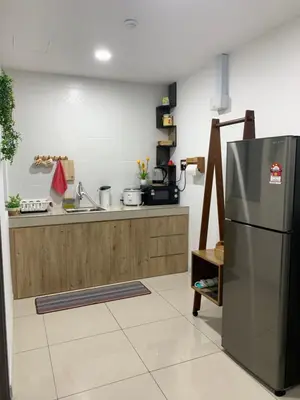 a kitchen with a stainless steel refrigerator at Ipoh Homestay - Manhattan Condominium with Water Park & Leisure Facilities in Ipoh