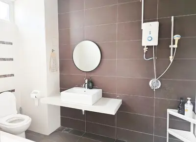 a bathroom with a sink and a mirror and a toilet at Ocean 27 Batu Ferringhi Shamrock Beach 6 Bedroom 22pax with Pool in Batu Ferringhi