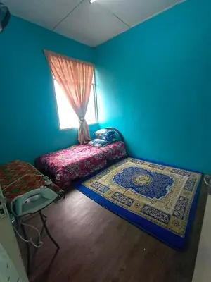 a blue room with a bed and a window at Hazaff Homestay in Sungai Petani
