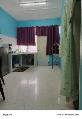 a dress hanging on a wall in a room at Hazaff Homestay in Sungai Petani