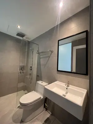 a bathroom with a toilet and a sink and a mirror at Ninety Guest House in Ipoh