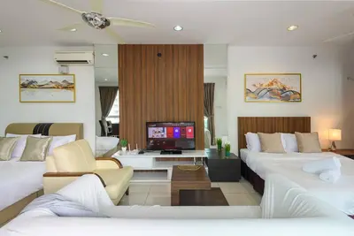 a living room with two white couches and a tv at Comfy Studio/Gurney/Mansion One in George Town