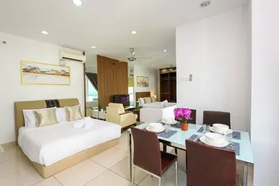 a hotel room with a bed and a dining table at Comfy Studio/Gurney/Mansion One in George Town