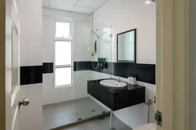 a white bathroom with a sink and a mirror at Comfy Studio/Gurney/Mansion One in George Town