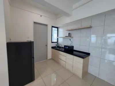 a kitchen with a black counter and a refrigerator at Praicon Tower - Premium Suite in Butterworth