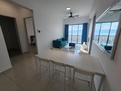 a kitchen with a table and chairs and a living room at Praicon Tower - Premium Suite in Butterworth