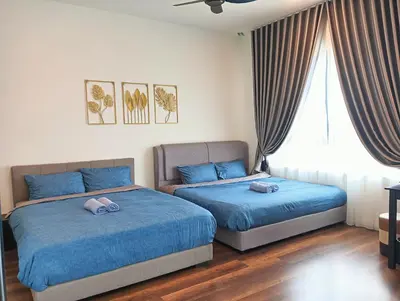 two beds in a bedroom with blue sheets at Studio in Sunway Onsen @ Lost World of Tambun for 4 in Ipoh