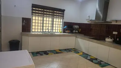 a kitchen with a sink and a floor with a window at Ipoh Family Villa-Spacious Stay for 21 or 42Pax in Ipoh