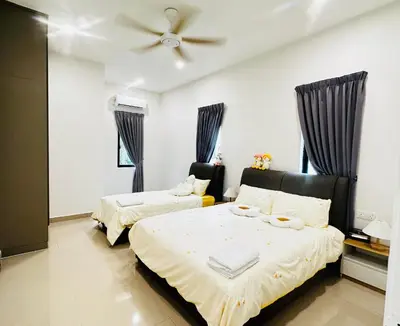 a bedroom with two beds and a ceiling fan at \u300aUntitled HomeStay\u300bSitiawan in Sitiawan