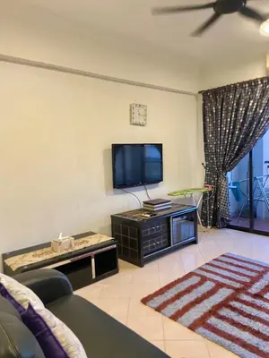 a living room with a tv and a couch at Homestay Legacy Kamariah Ahmad,Lumut in Lumut