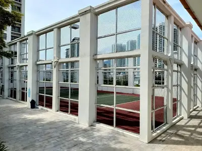 a tennis court inside of a building with windows at Perfect Marina Stay@ Strait Quay /w Big Balcony + Carpark in Bagan Jermal