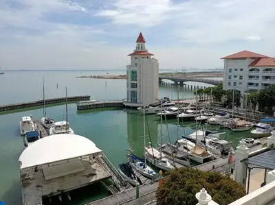 a marina with boats in the water next to buildings at Perfect Marina Stay@ Strait Quay /w Big Balcony + Carpark in Bagan Jermal