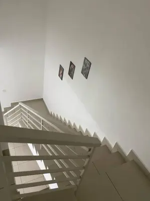 a staircase with three pictures on the wall at KY Happiness Homestay Tanjong Karang \u5feb\u4e50\u6c11\u5bbf in Tanjung Karang
