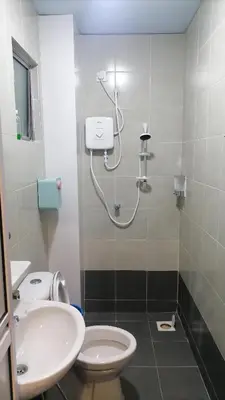 a bathroom with a shower and a toilet and a sink at stoberi cekelat homestay in Brinchang