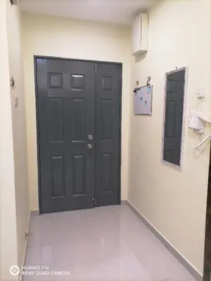 a black door in a room with a tile floor at stoberi cekelat homestay in Brinchang