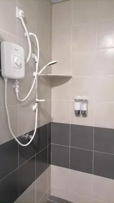 a shower in a bathroom with a shower head at stoberi cekelat homestay in Brinchang