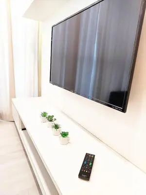 a flat screen tv sitting on top of a white table at SG10-4Pax 2rooms Studio Georgetown in George Town