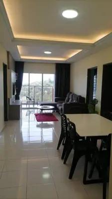 a living room with a couch and a table and chairs at Stobericekelathomestay in Cameron Highlands