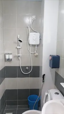 a bathroom with a shower with a toilet and a sink at Stoberi CekelatHomestay in Brinchang