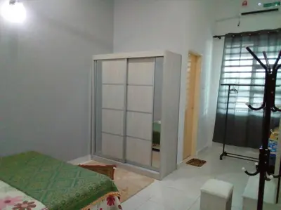 a bedroom with a bed and a large window at Percutian Di Taiping & Bukit Merah Laketown in Kamunting