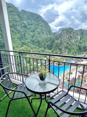 a table and chairs on a balcony with a view at 2-8pax Ipoh Nomado Onsen suites by Sunway Onsen Lost world of Tambun in Ipoh
