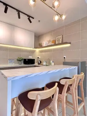 a kitchen with a large counter with two chairs at 2-8pax Ipoh Nomado Onsen suites by Sunway Onsen Lost world of Tambun in Ipoh