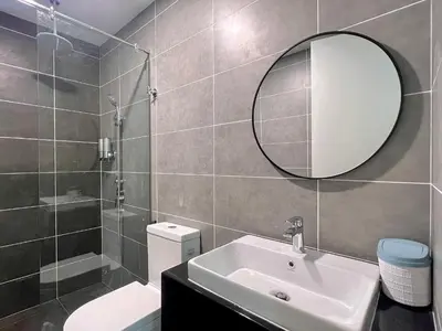 a bathroom with a sink and a mirror and a toilet at 2-8pax Ipoh Nomado Onsen suites by Sunway Onsen Lost world of Tambun in Ipoh