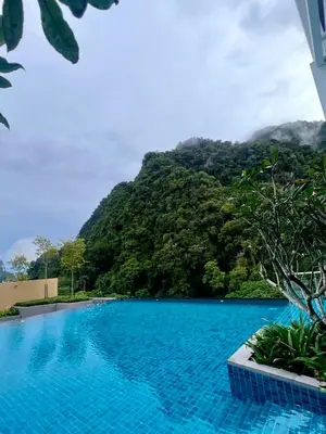 a swimming pool with a mountain in the background at 2-8pax Ipoh Nomado Onsen suites by Sunway Onsen Lost world of Tambun in Ipoh