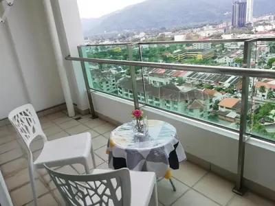 a balcony with a table and chairs and a view at Exclusive Studio/15th/ 1~4pax/ Gurney/ Mansion One in George Town