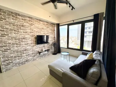 a living room with a couch and a brick wall at Tropicana 218 Macalister by CC in George Town