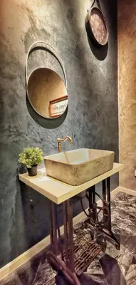 a bathroom with a stone sink and a mirror at IPOH AGONG HOMESTAY by ONE LIFE FOUR SEASON GUESTHOUSE in Ipoh